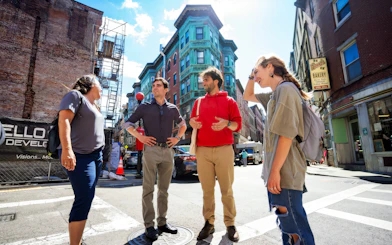 Group of people exploring Boston's North End along the Freedom Trail.
