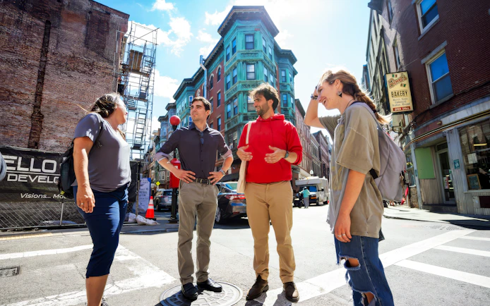 Group of people exploring Boston's North End along the Freedom Trail.