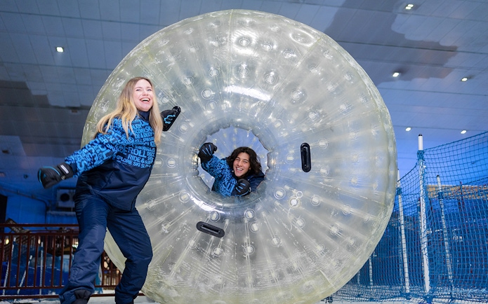 Guests enjoying zorbing at Ski Dubai indoor snow park.