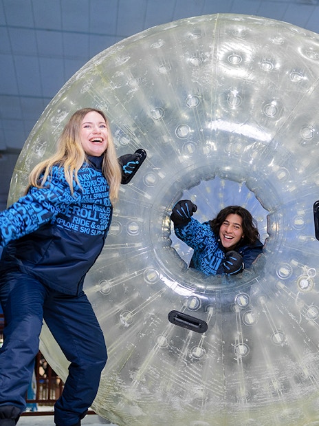 Guests enjoying zorbing at Ski Dubai indoor snow park.