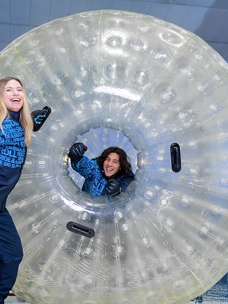 Guests enjoying zorbing at Ski Dubai indoor snow park.
