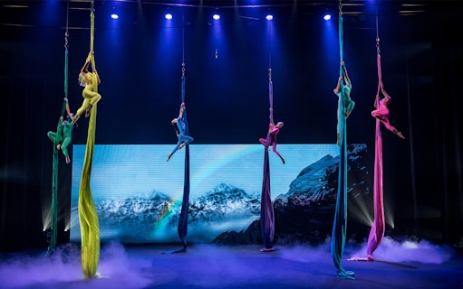 Aerial performers in colorful costumes at Earth Symphony - Green Cirque Fest 2024.