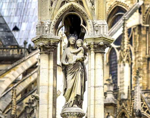 Notre-Dame Cathedral facade with tourists using audio guides in Paris.
