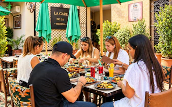 Guests dining at La Gare de la Medina rooftop in Marrakech.