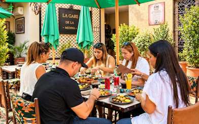 Guests dining at La Gare de la Medina rooftop in Marrakech.