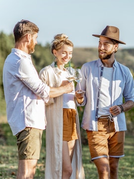Friends enjoying wine in Barossa Valley vineyard.