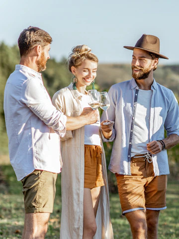 Friends enjoying wine in Barossa Valley vineyard.