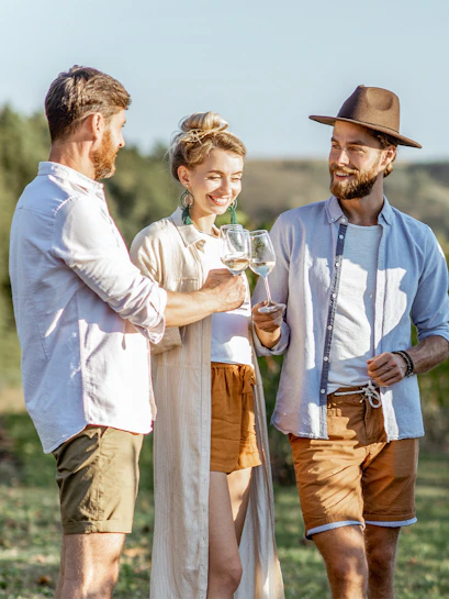 Friends enjoying wine in Barossa Valley vineyard.