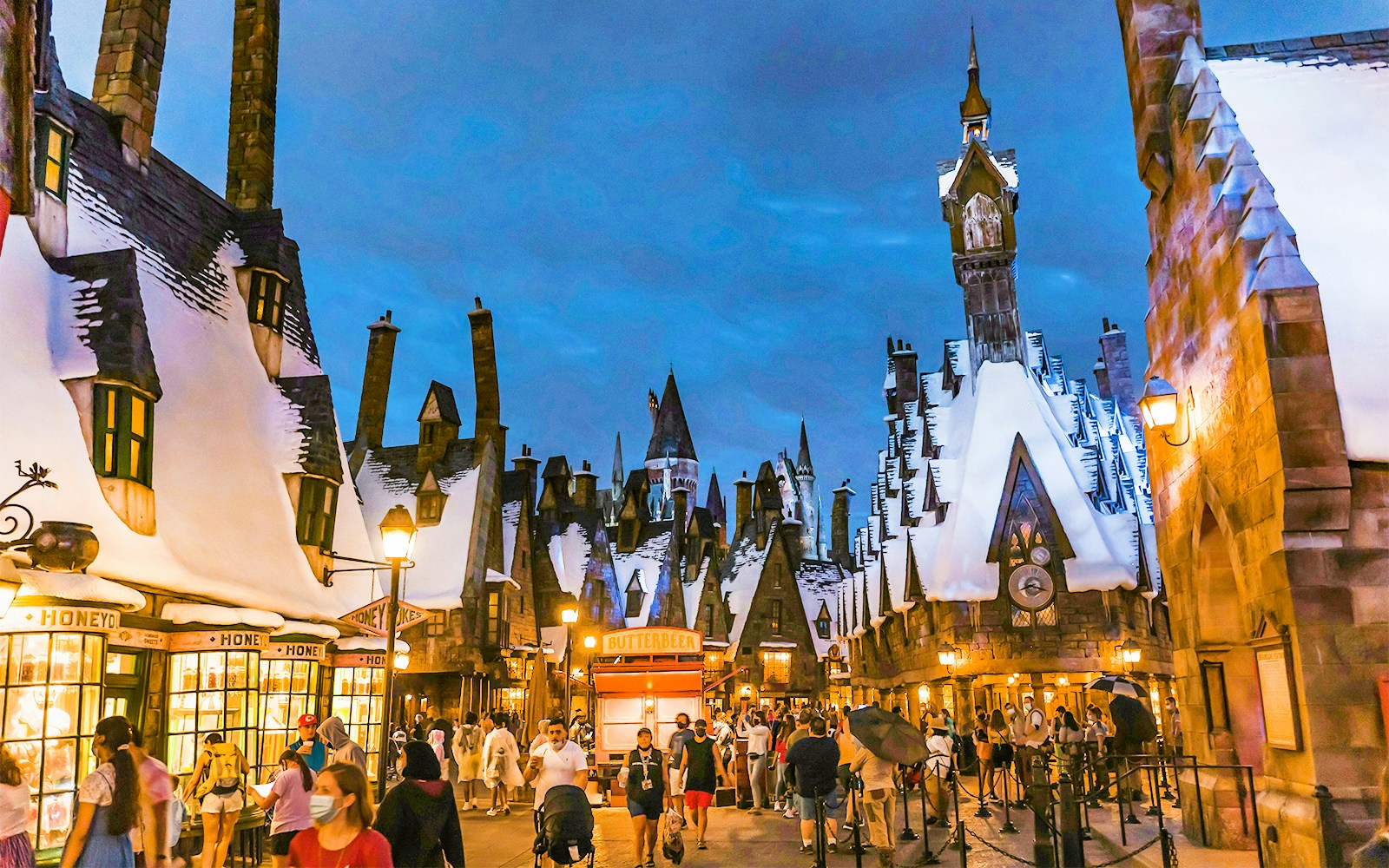 Hogsmeade village with snow-covered rooftops at Universal Orlando's Winter Magic event.