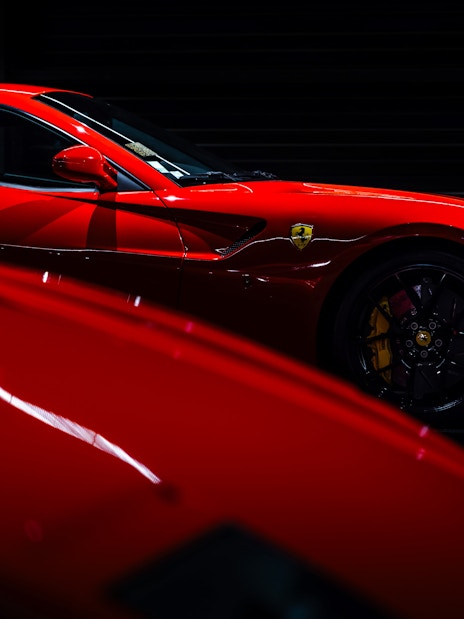 Red sports car on display at Coligny Car Museum, Lyon, France.