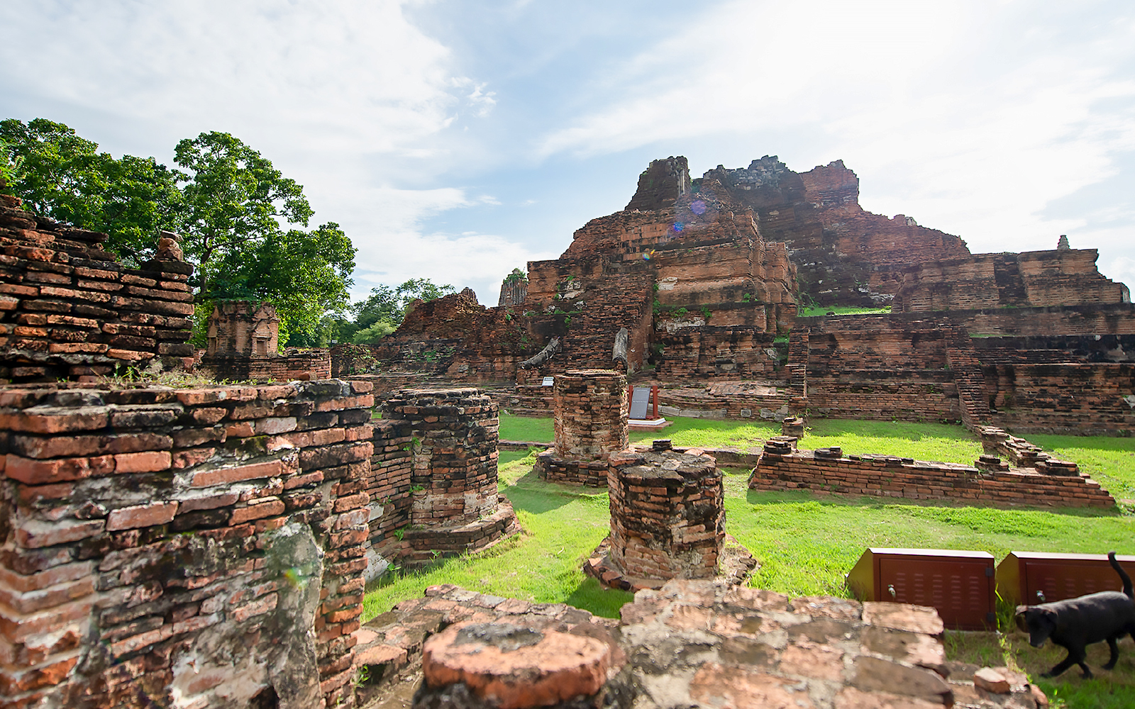 Crumbling brick ruins of an ancient temple in Ayutthaya, Thailand.