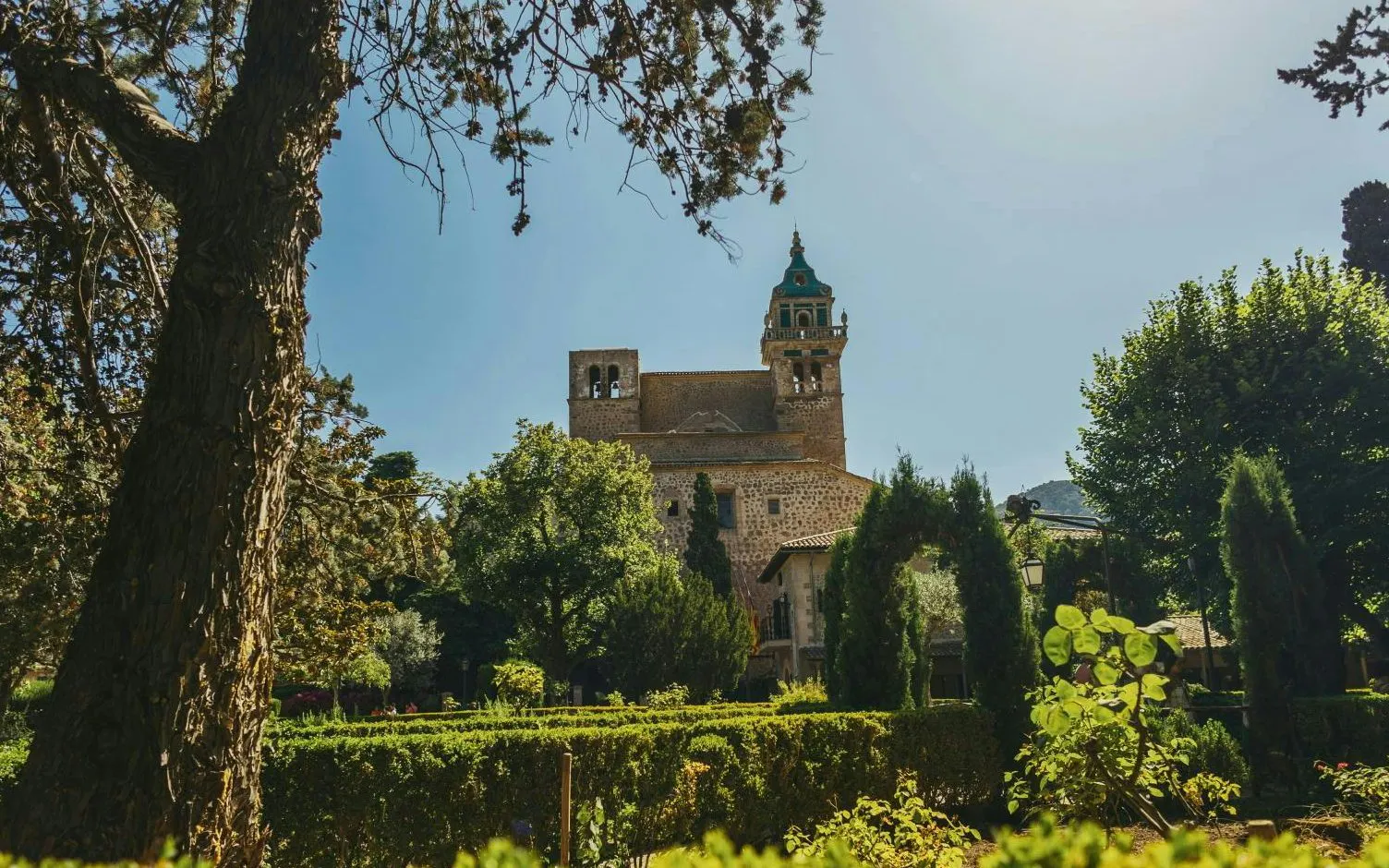 Valldemossa Charterhouse surrounded by lush gardens in Mallorca, Spain.