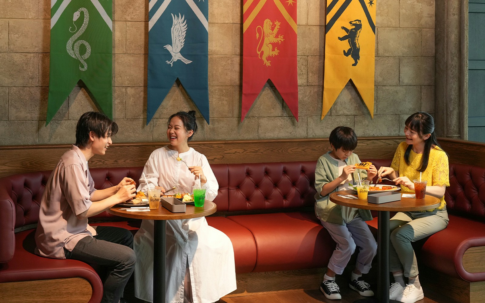 Visitors dining at Warner Bros. Studio Tour Tokyo, surrounded by Harry Potter-themed decor.