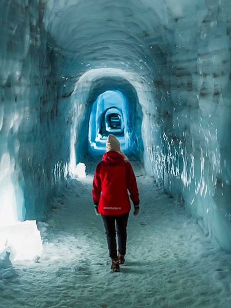 Guests walking through Langjokull ice tunnel in Iceland.