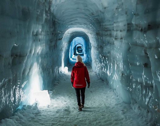 Guests walking through Langjokull ice tunnel in Iceland.