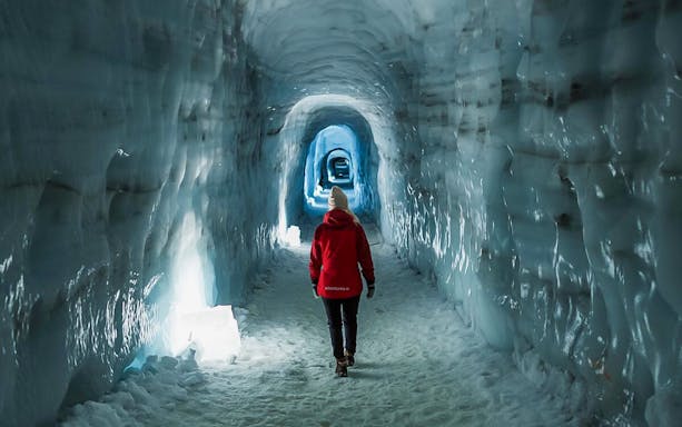 Guests walking through Langjokull ice tunnel in Iceland.