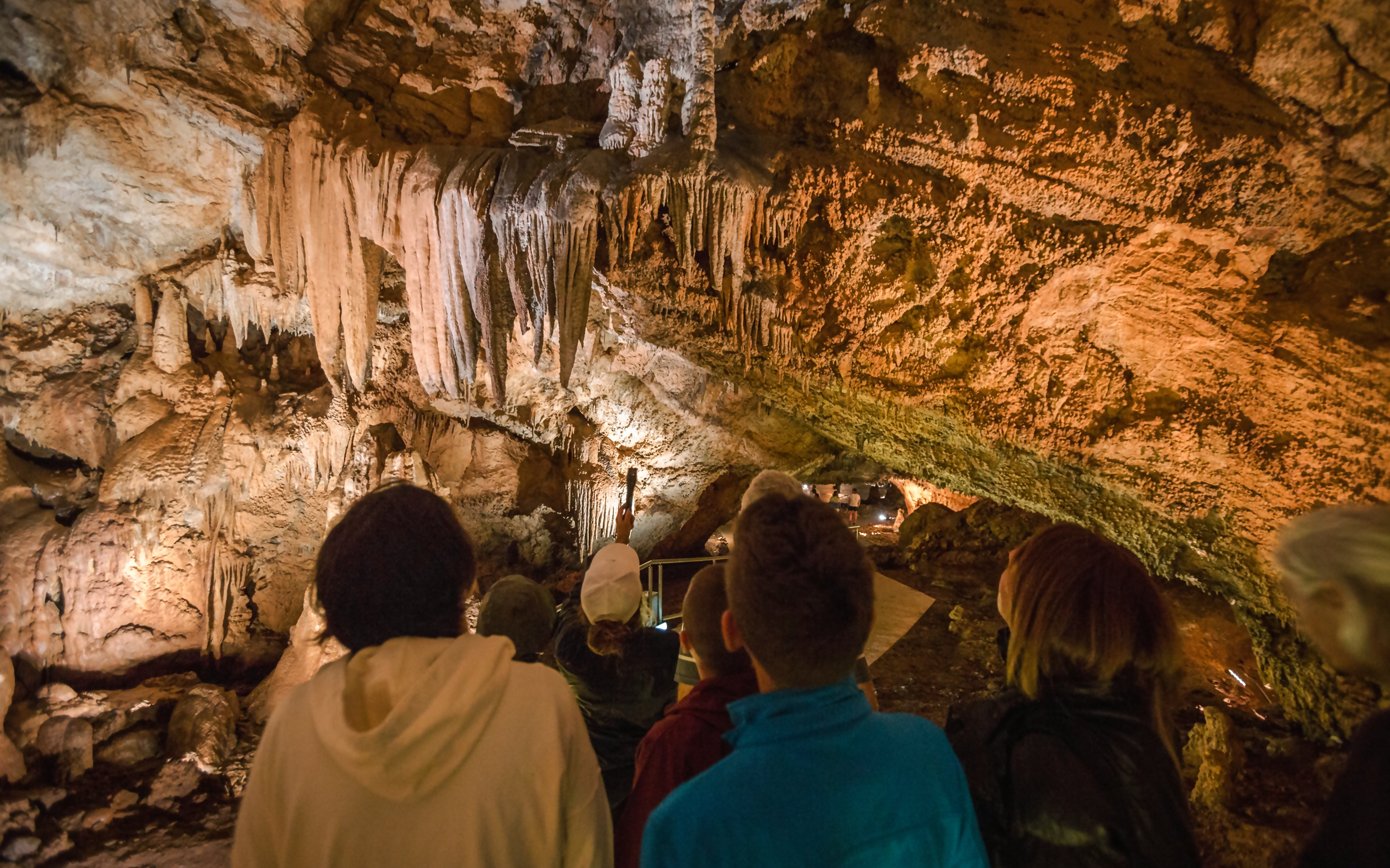 Tourists exploring stalactites in Lipa Cave, Cetinje.