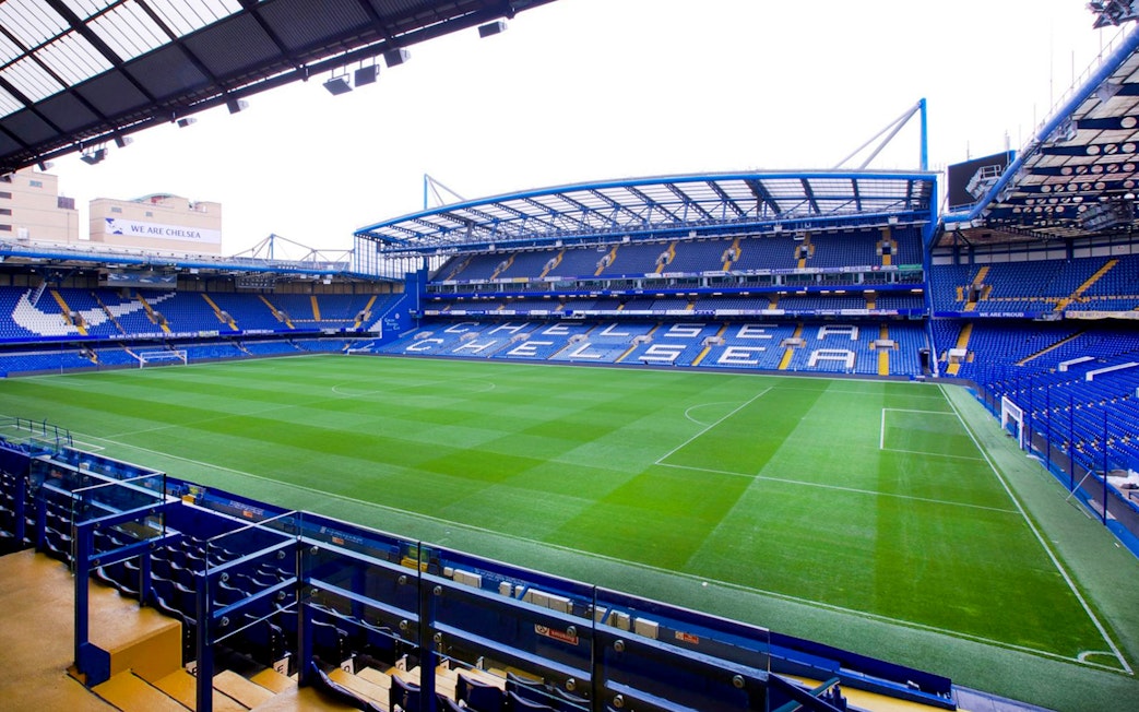 Chelsea FC Stadium with empty stands and field, view from seating area.