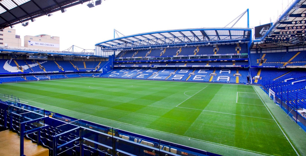 Chelsea FC Stadium with empty stands and field, view from seating area.