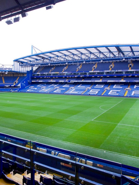 Chelsea FC Stadium with empty stands and field, view from seating area.