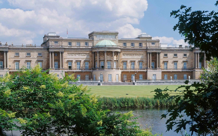 Buckingham Palace viewed from the garden with a pond in the foreground.