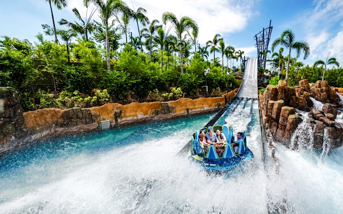 Raft descending the Infinity Falls river rapids ride at SeaWorld Orlando.