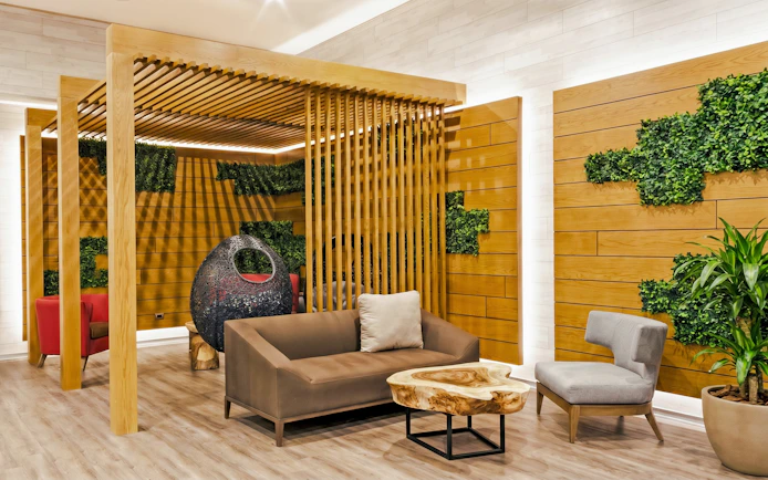 Rest area seating with wooden decor at MERA Business Lounge, Terminal 3, Cancún International Airport.