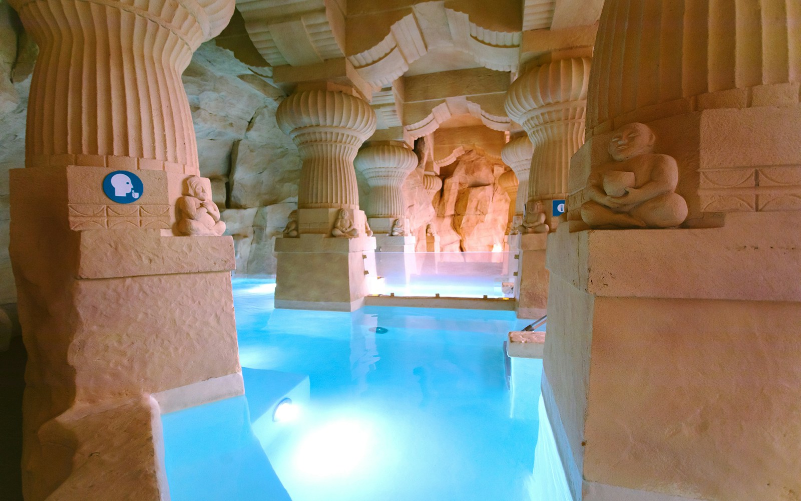 Indo-Roman baths at Caldea Spa with people relaxing in thermal pools, Andorra.