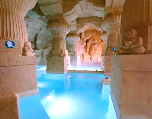 Indo Roman baths at Caldea Spa with people relaxing in thermal pools, Andorra.