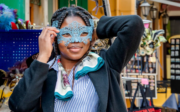 Person holding a Venetian mask in a market on Murano Island, Venice.