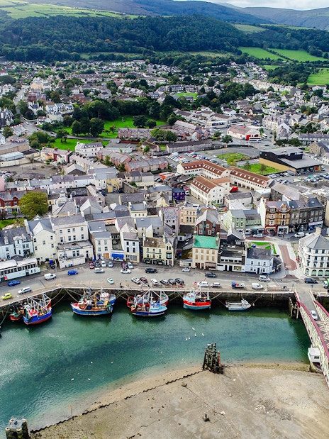 Aerial view of Ramsey Harbour with fishing boats and townscape, Isle of Man.