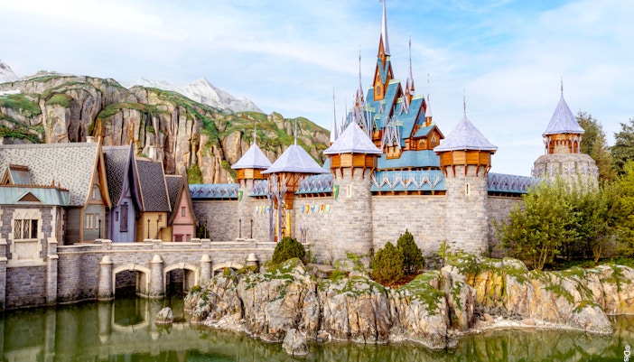Arendelle castle and village at Disneyland World of Frozen, surrounded by rocky landscape.
