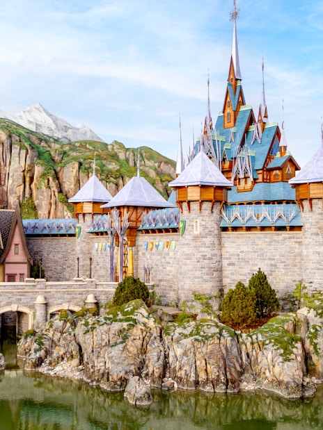 Arendelle castle and village at Disneyland World of Frozen, surrounded by rocky landscape.