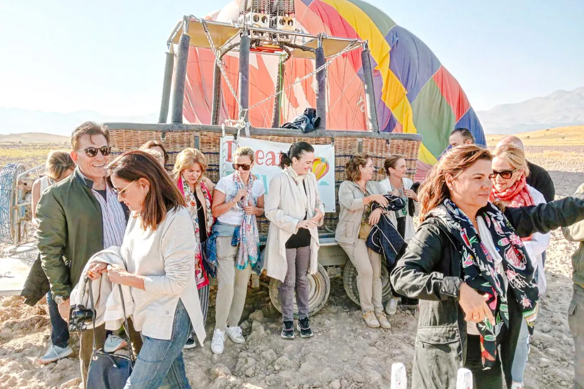 Group preparing for hot air balloon flight at sunrise in Ihlara Canyon, Cappadocia.