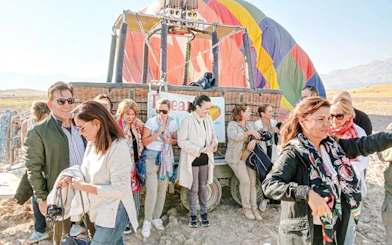 Group preparing for hot air balloon flight at sunrise in Ihlara Canyon, Cappadocia.