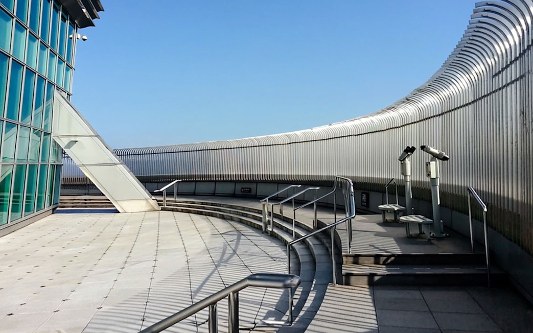 Observation deck of Taipei 101 with telescopes and glass panels.