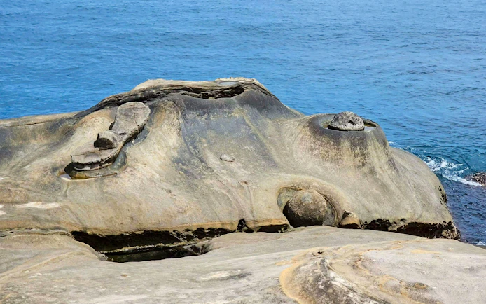 Fairy's Shoe rock formation at Yehliu Geopark, New Taipei City, shaped by marine erosion.