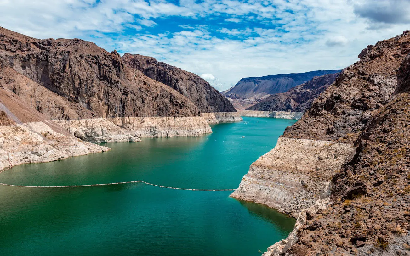 Red Rock Canyon view with rocky cliffs and turquoise water near Las Vegas.