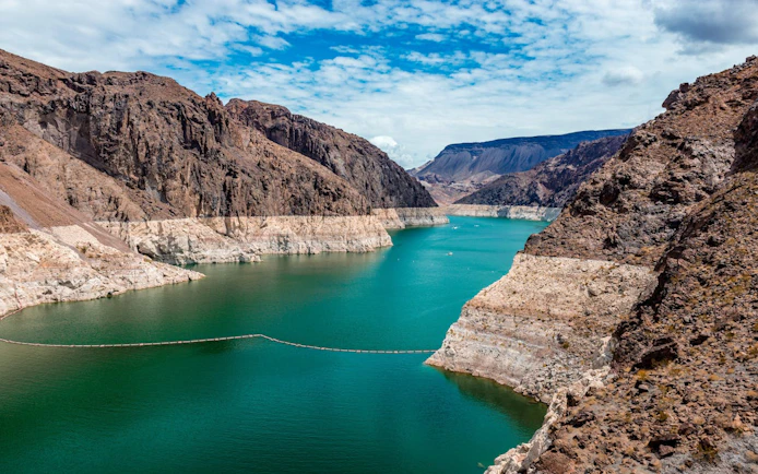 Red Rock Canyon view with rocky cliffs and turquoise water near Las Vegas.