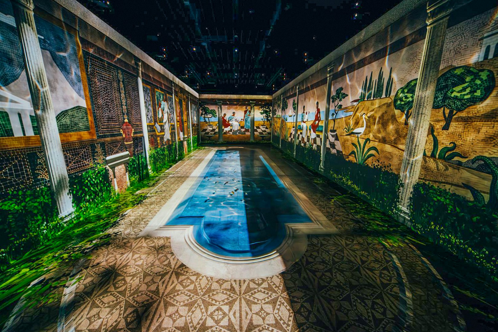 Mosaic murals depicting ancient Pompeii scenes with a central pool.