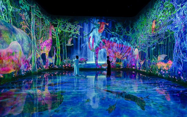 teamLab Planets Tokyo, immersive digital forest with colorful animals and visitors exploring.