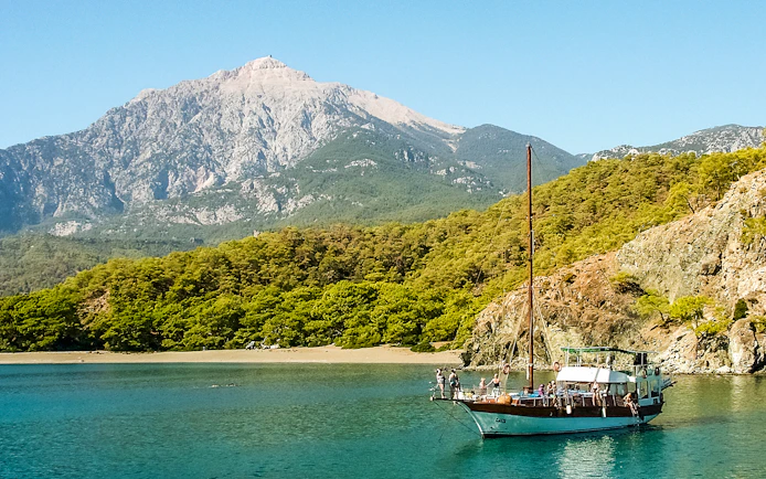 Boat sailing near Phaselis with Mount Tahtali in the background, Antalya tour.