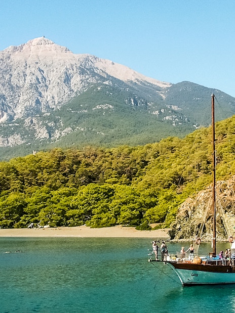 Boat sailing near Phaselis with Mount Tahtali in the background, Antalya tour.