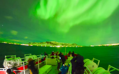 Guests viewing northern lights from a cruise ship deck in Iceland.