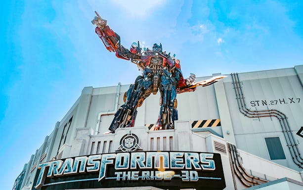 Transformers The Ride 3D entrance at Universal Orlando, Florida with Optimus Prime statue.