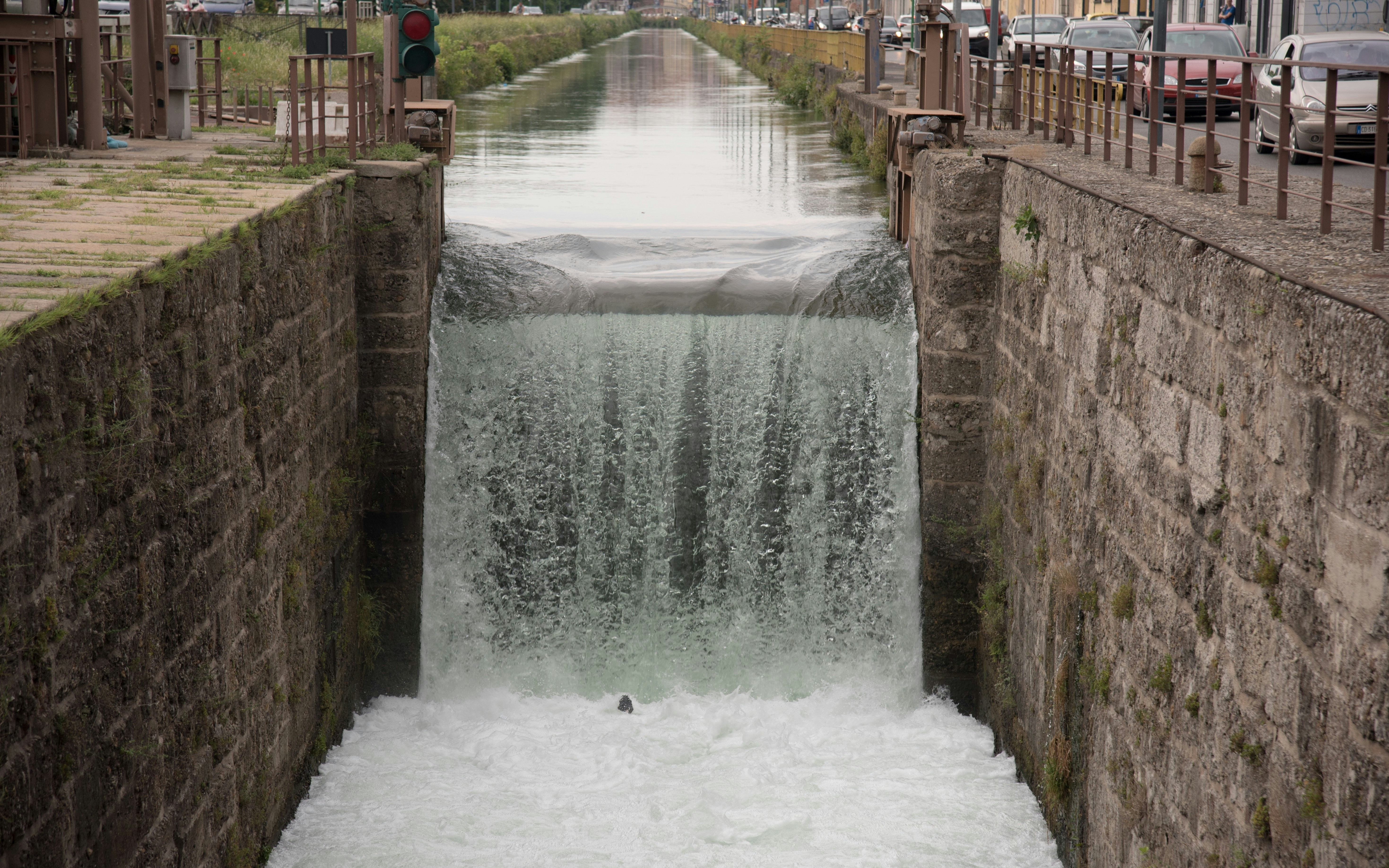 Conca Fallata lock in Milan with water cascading over stone walls.