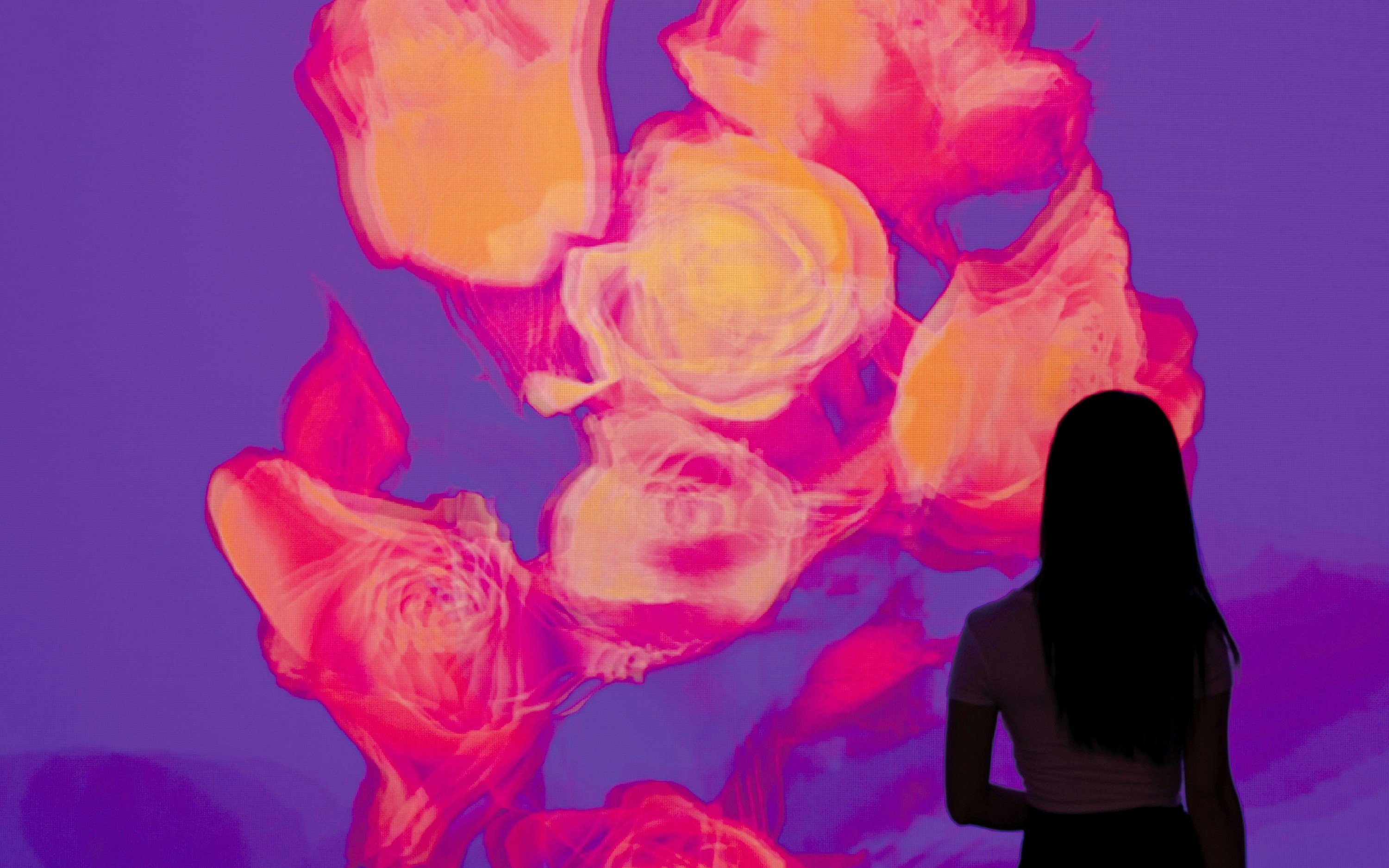 Visitor admiring digital art display at Arte Museum, New York.