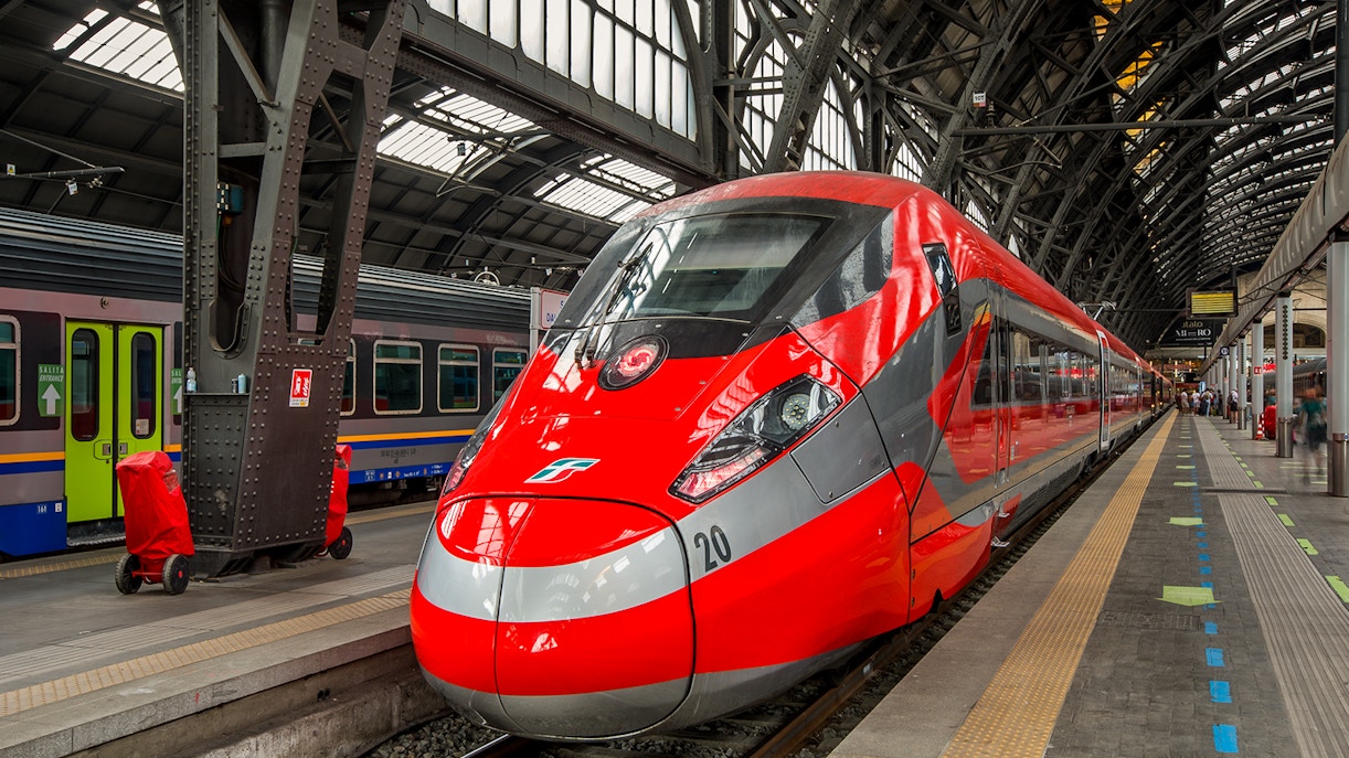 Florence train station with travelers boarding for 7-Day Italy Train Pass journey.