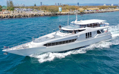 Luxury yacht cruising near Gold Coast for whale watching tour.