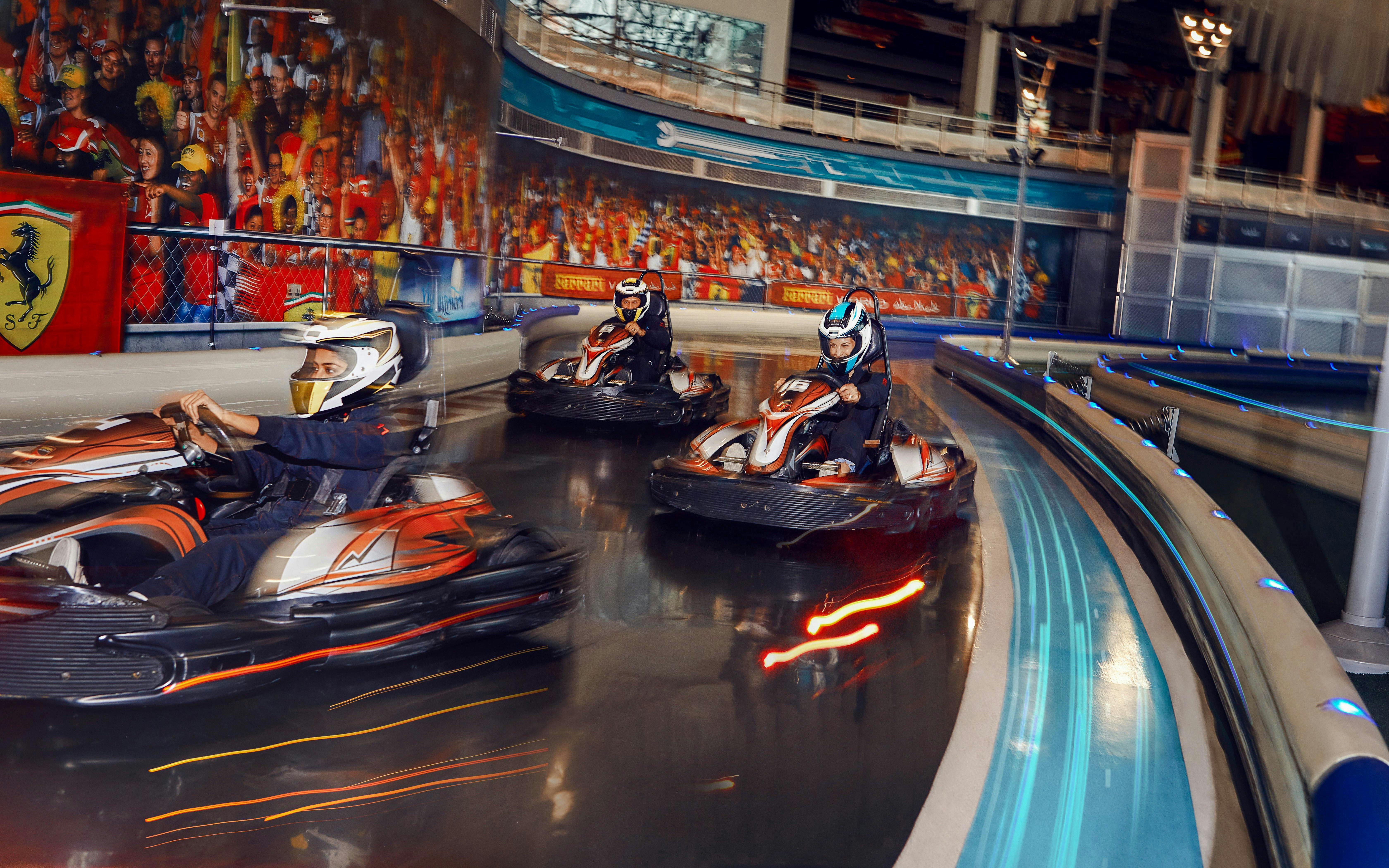 Go-kart racing at Ferrari World Abu Dhabi indoor track.